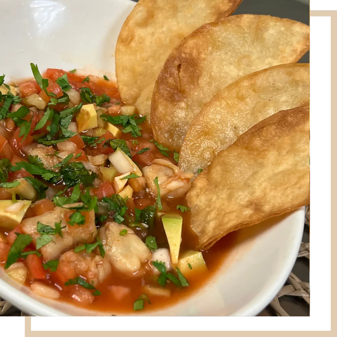 Shrimp Ceviche - Citrus-marinated shrimp layered with avocado and hot sauce, served on two crispy tostadas