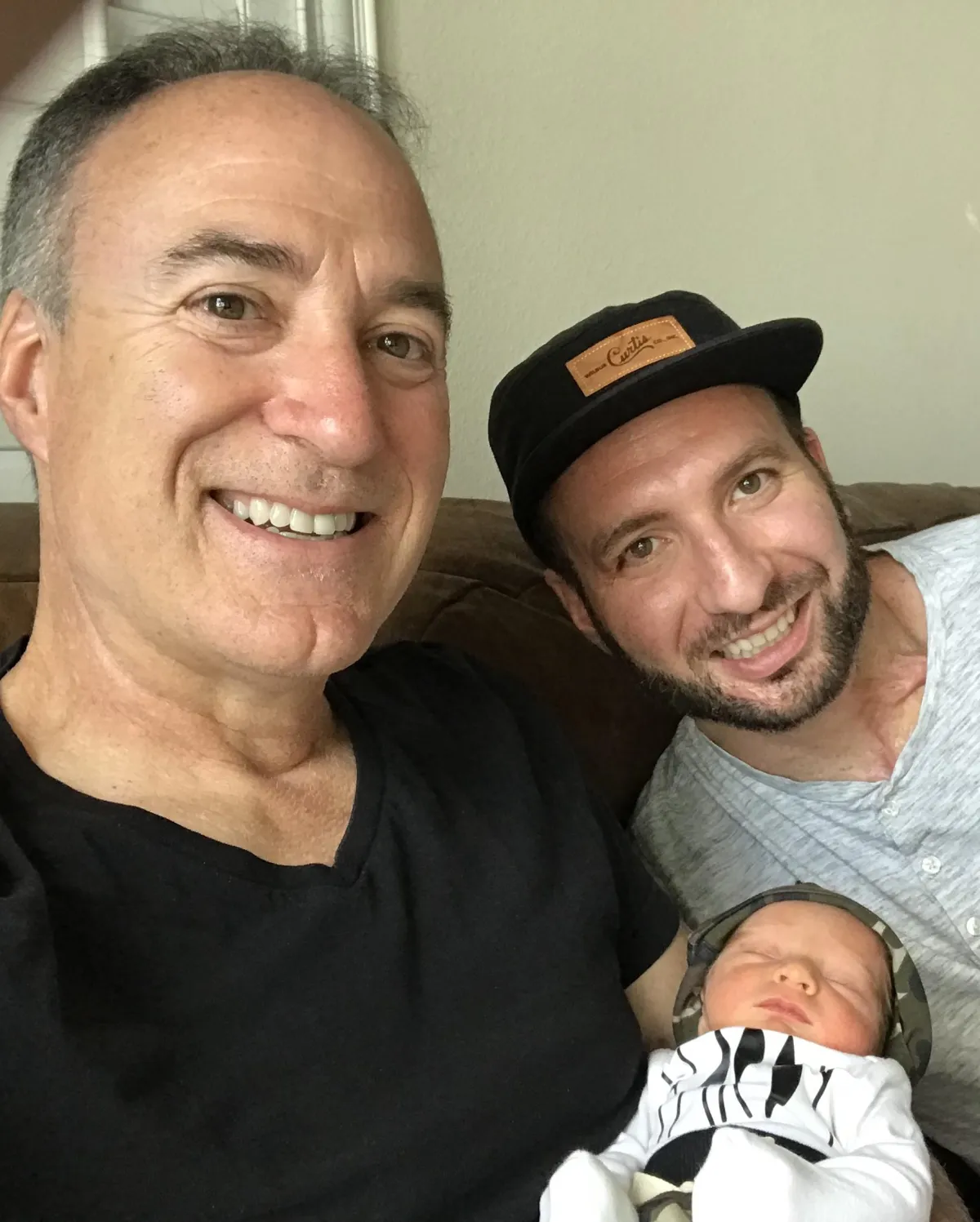 person using phone and laptop computer