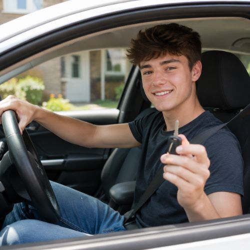Teen driver smiling and holding car keys after an affordable driving lesson with Cameo Driving School in Bucks County.