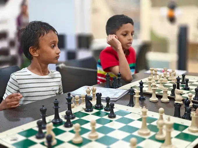 Chess students playing games during a coaching session at CHESS KLUB