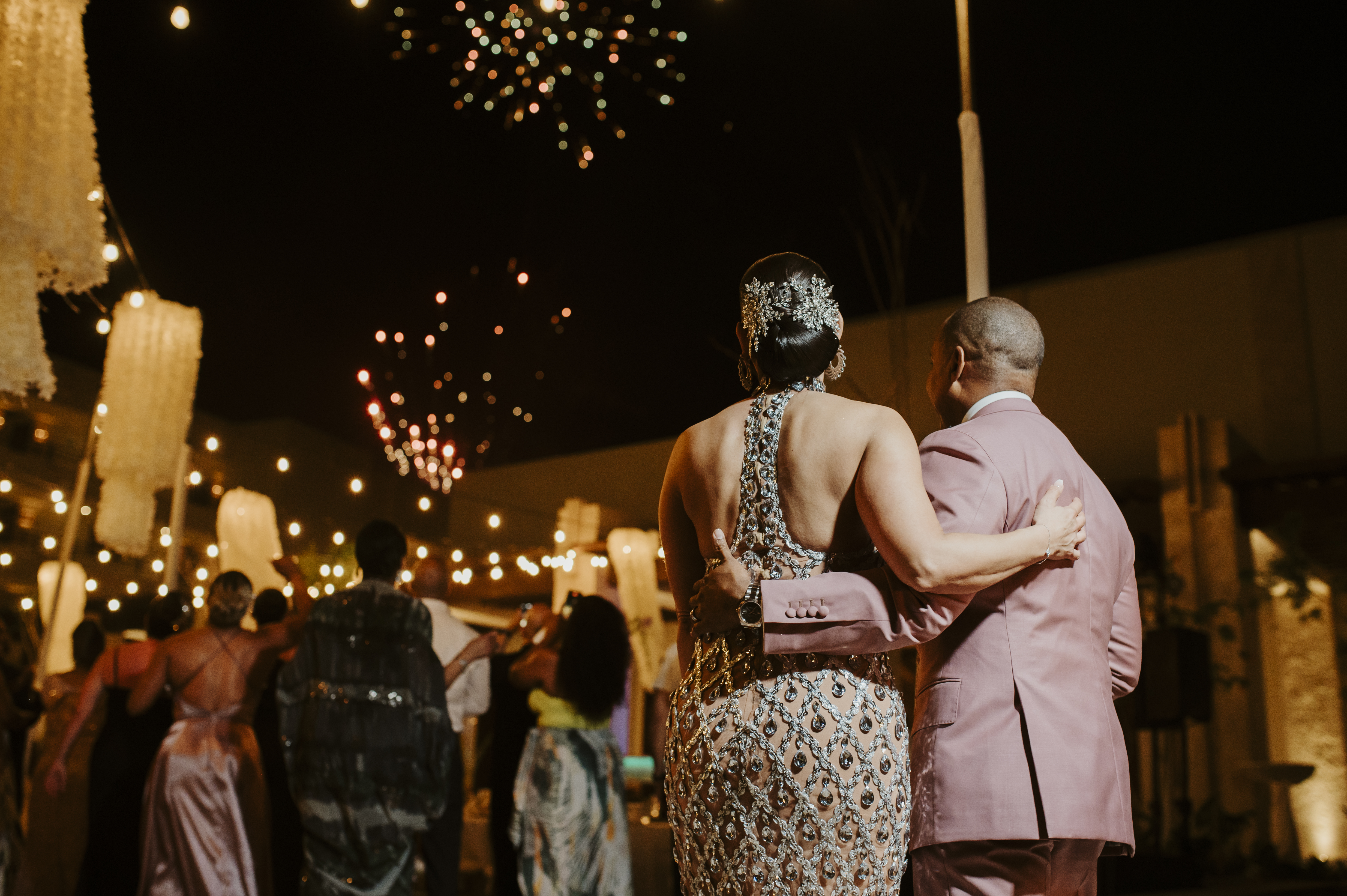 Two round tables with white flowers in vases.