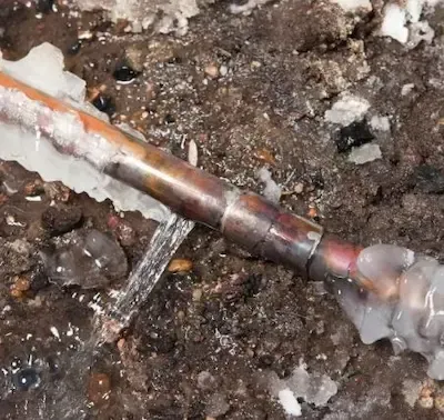 Frozen copper pipe joint cracked from ice damage needing urgent repair in Bexley