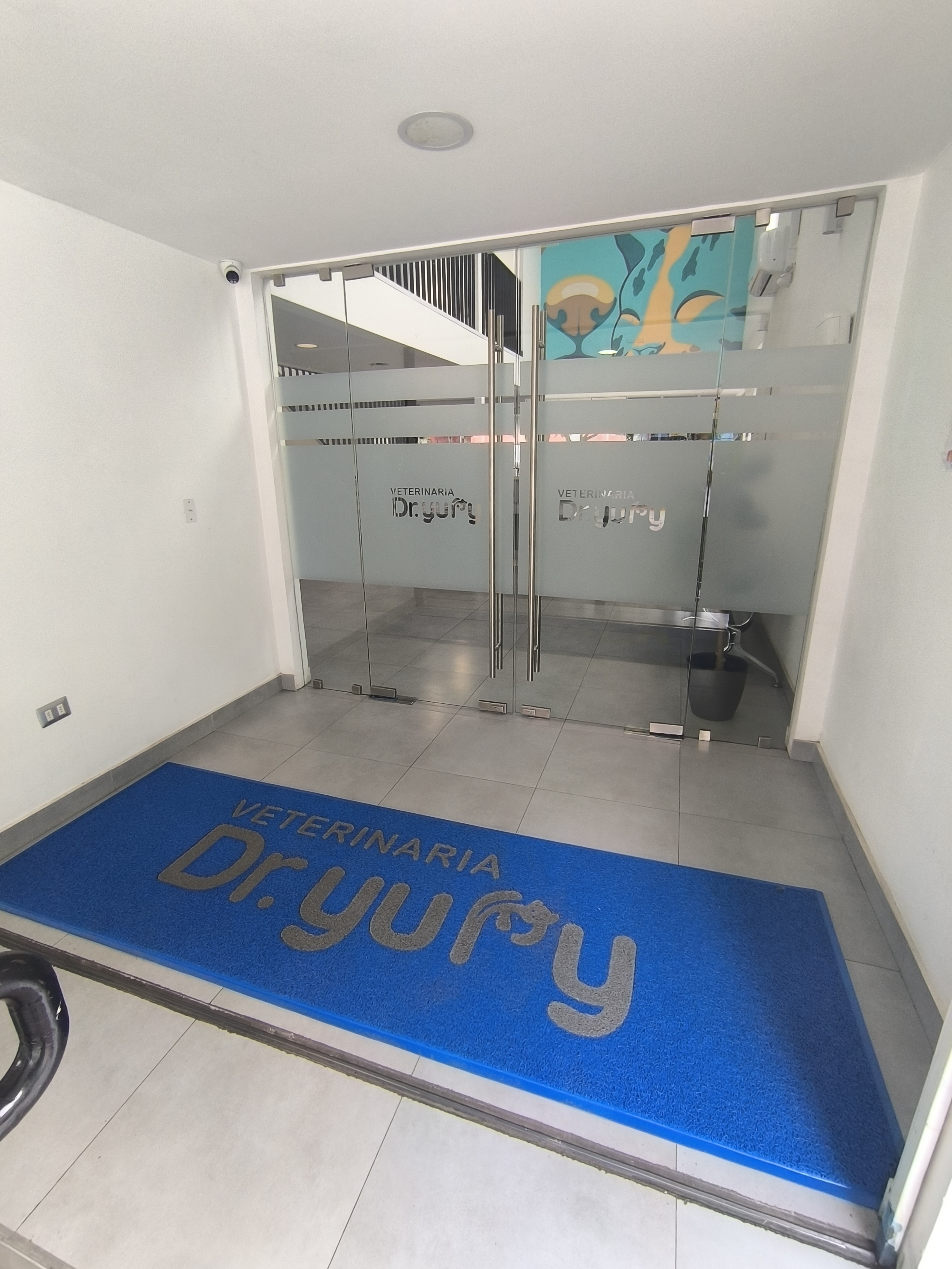 A white dog resting on a comfortable bed.