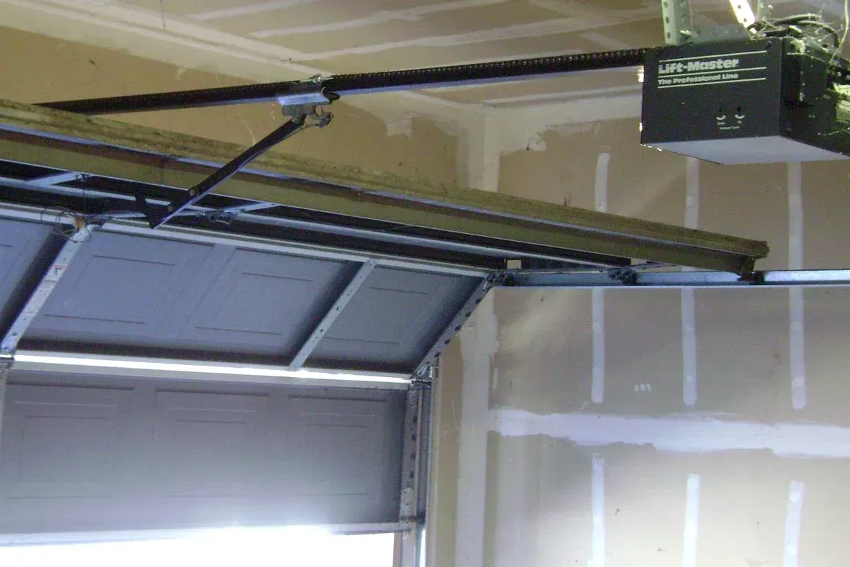 Technician repairing a residential garage door opener in Hampton Roads