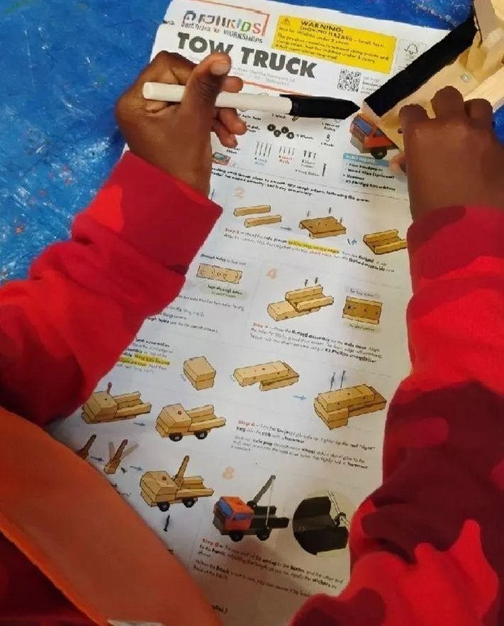 Boy picks paper out of different colored liquids