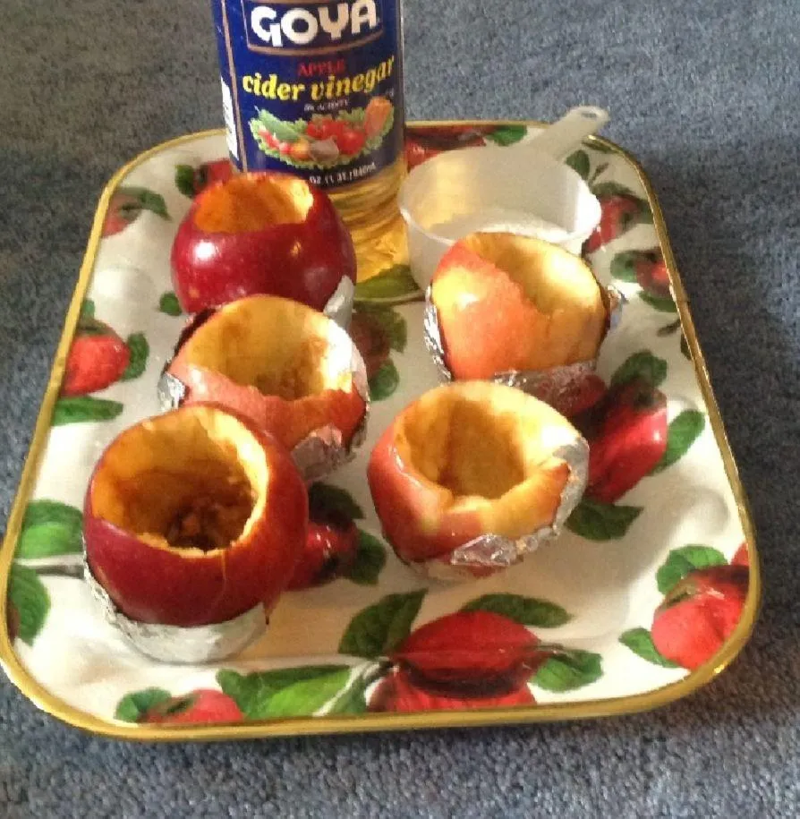 Child with headset smiles as he engages with laptop