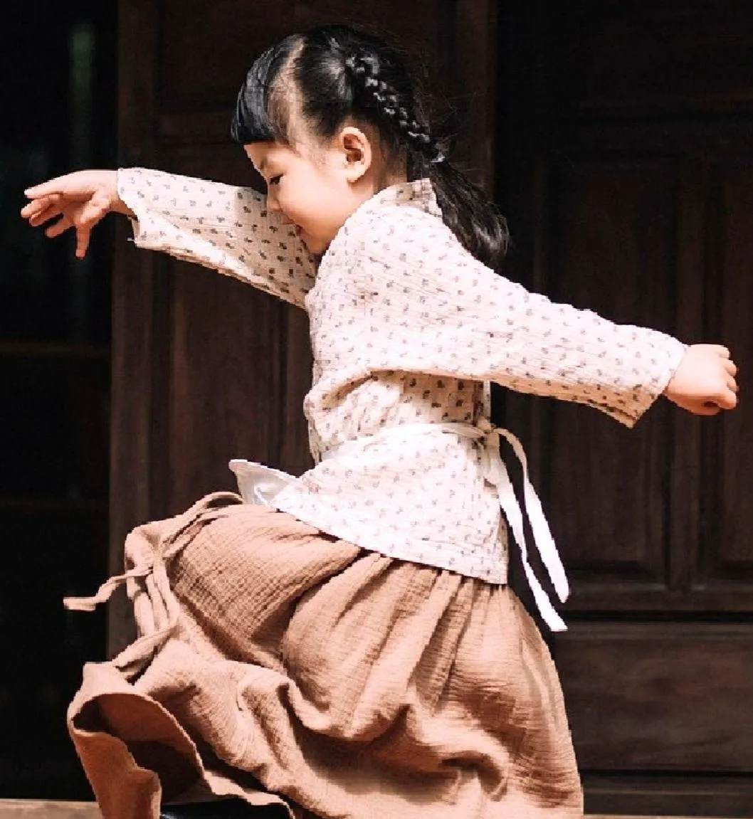 Child waves at laptop