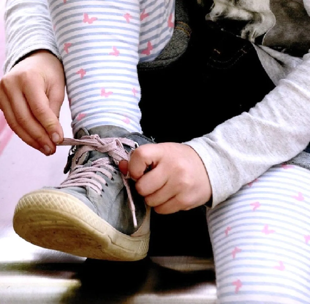 Child waves at laptop