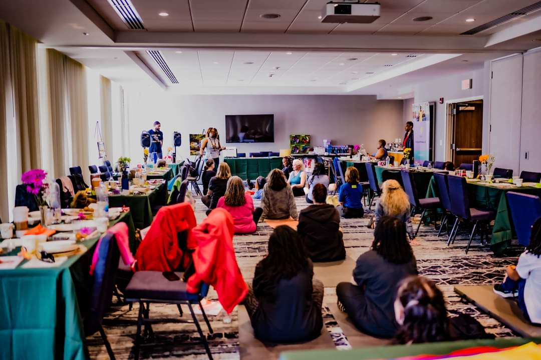woman in black tank top sitting on brown wooden log during daytime