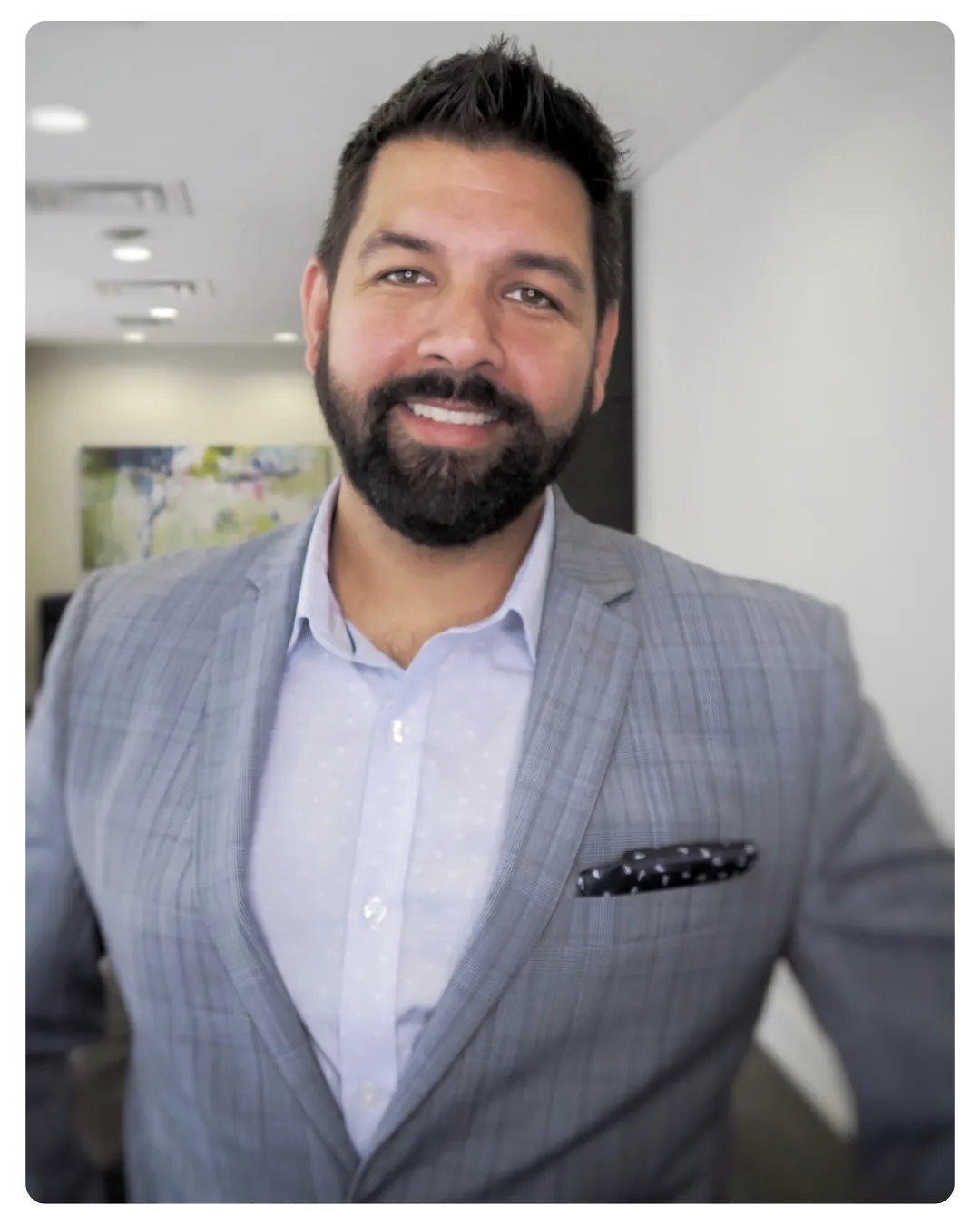 Dan, a friendly Canadian mortgage advisor in his 40s, smiling in a bright office with certificates on the wall.