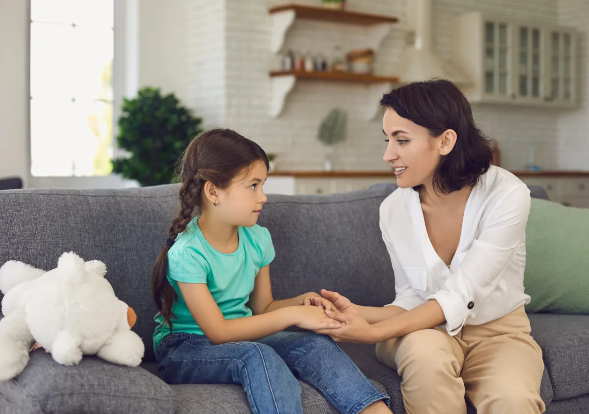 A person laying on the ground next to some shoes