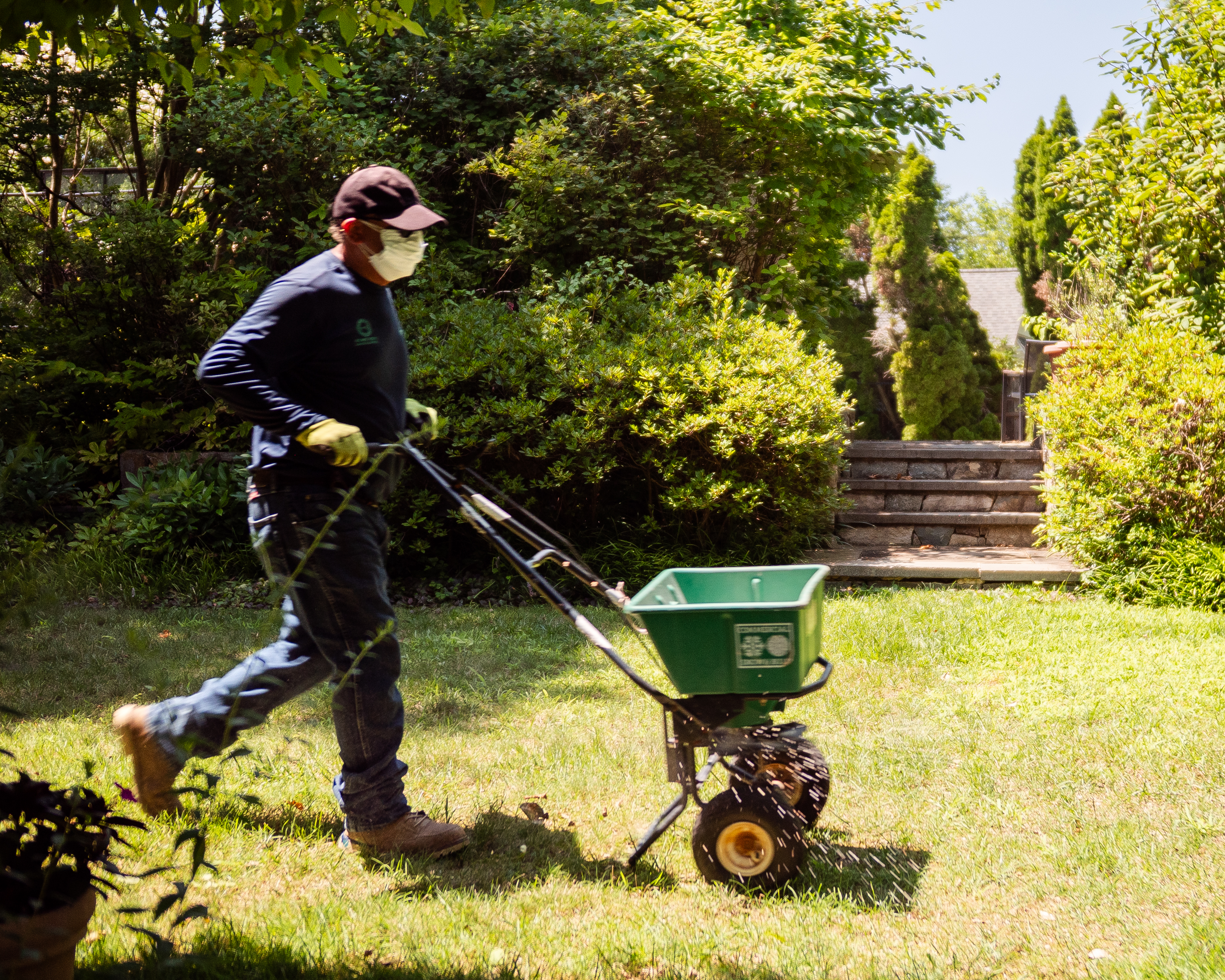 Master masons carefully placing premium stone elements in a finished garden space