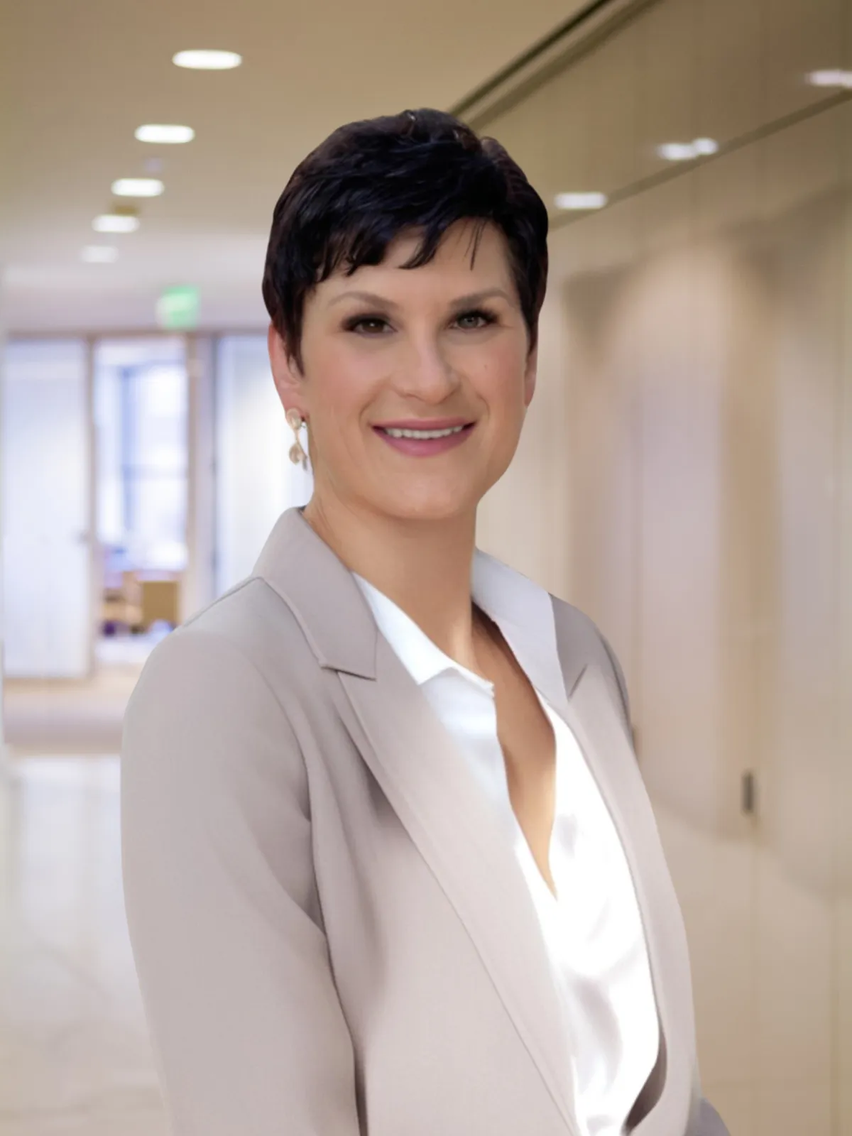 woman in blue denim jacket facing turned on monitor