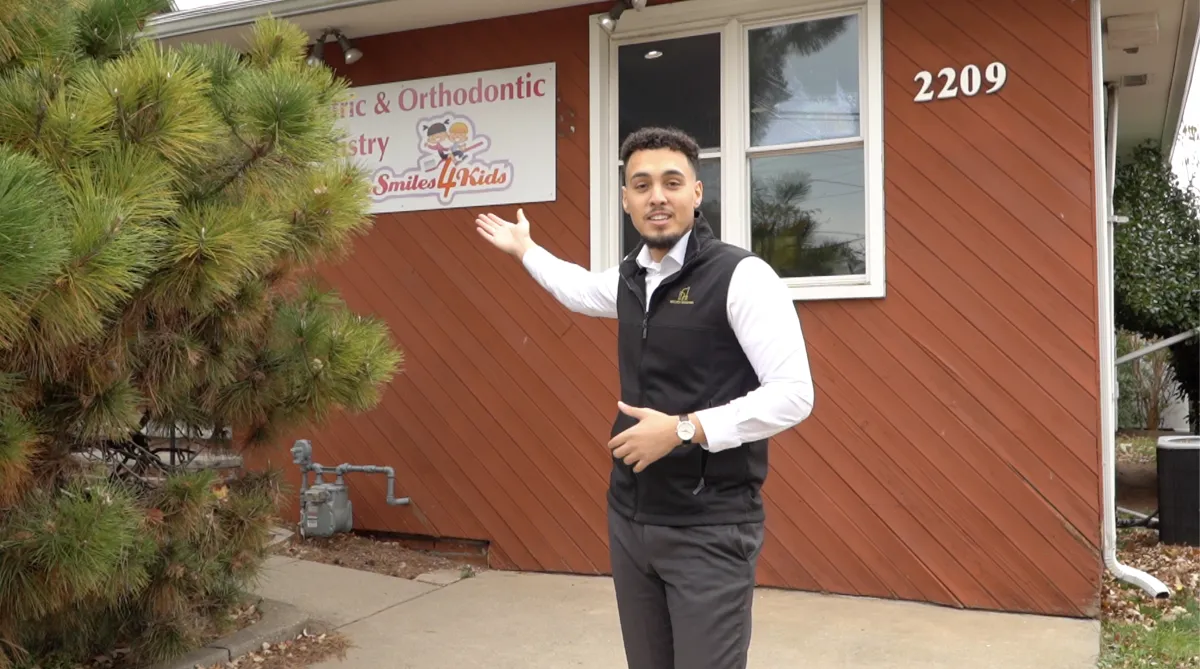 New Jersey real estate professional outside a residential property, helping homeowners sell their house with Meckey Estates.