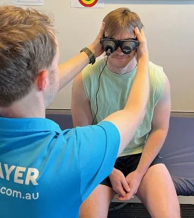 Physio assessing client with vestibular goggles