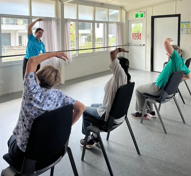 Physiotherapist leading community exercise class in Graceville