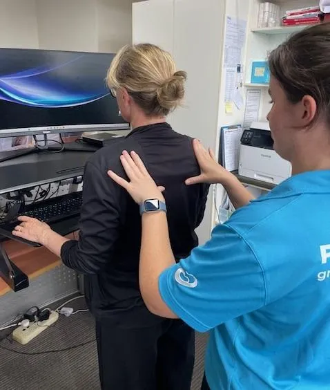 Physio assessing worker to prevent injuries