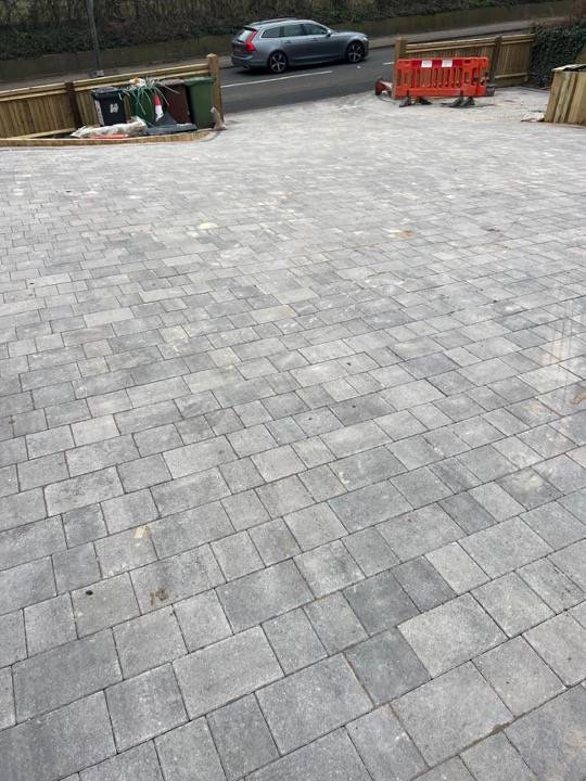 Large commercial block paved area showing car park scale installation