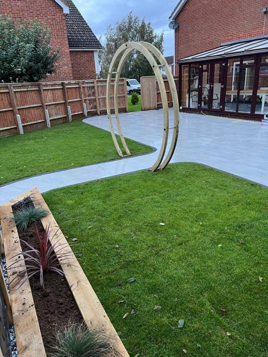 Full garden design with porcelain patio, turf and raised sleeper beds in Tring