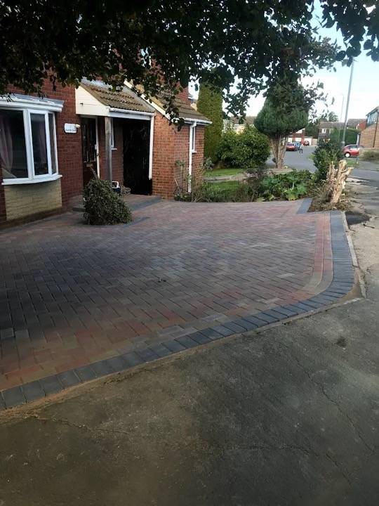 Block paved driveway in herringbone with red border at bungalow in Aylesbury