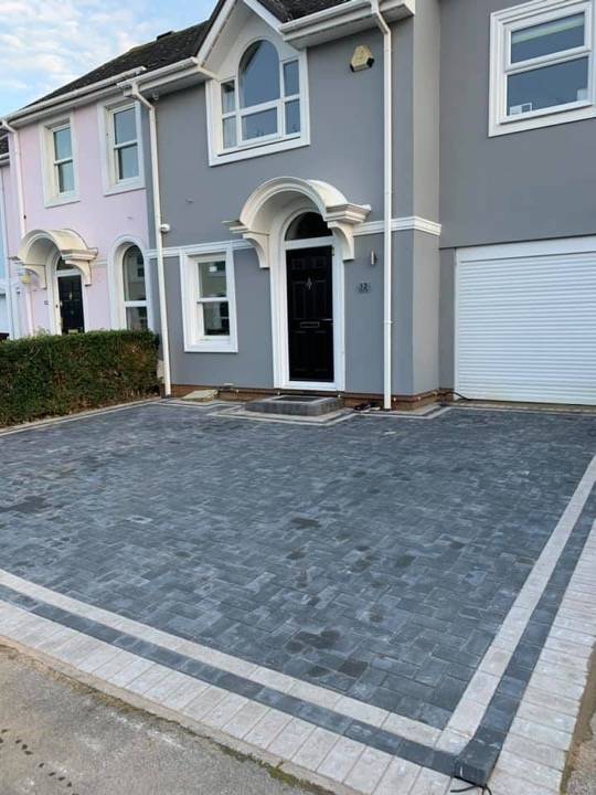 Charcoal herringbone block paved driveway with full house frontage