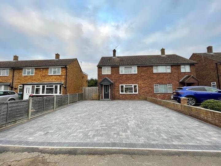 Grey and charcoal block paved driveway at semi-detached property