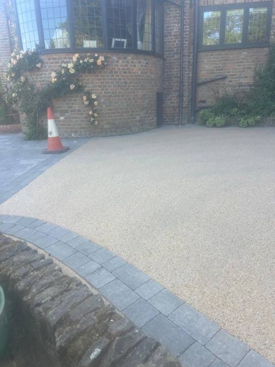 Resin bound driveway with cobble stone edging at period property