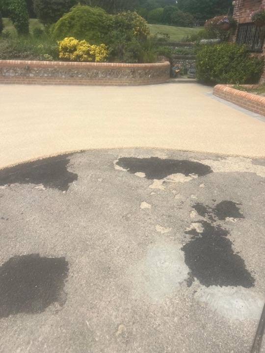 Driveway repair with tarmac patching on damaged surface