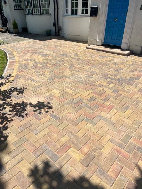 Buff herringbone block paved driveway in bright sunlight in Berkhamsted