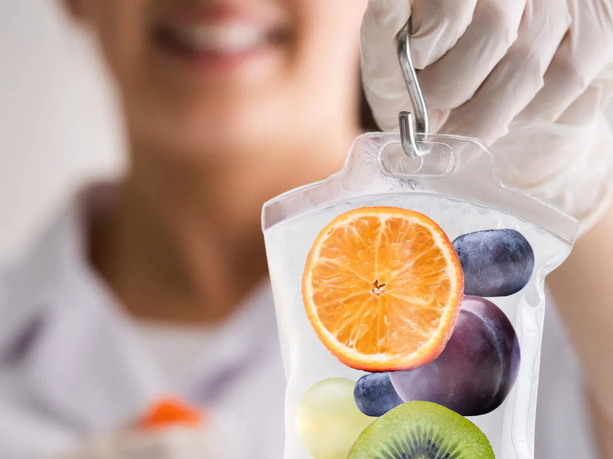 Barrel sauna with wood pile in grassy field.