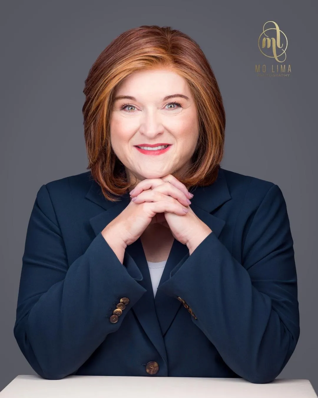 Woman folding hands under chin