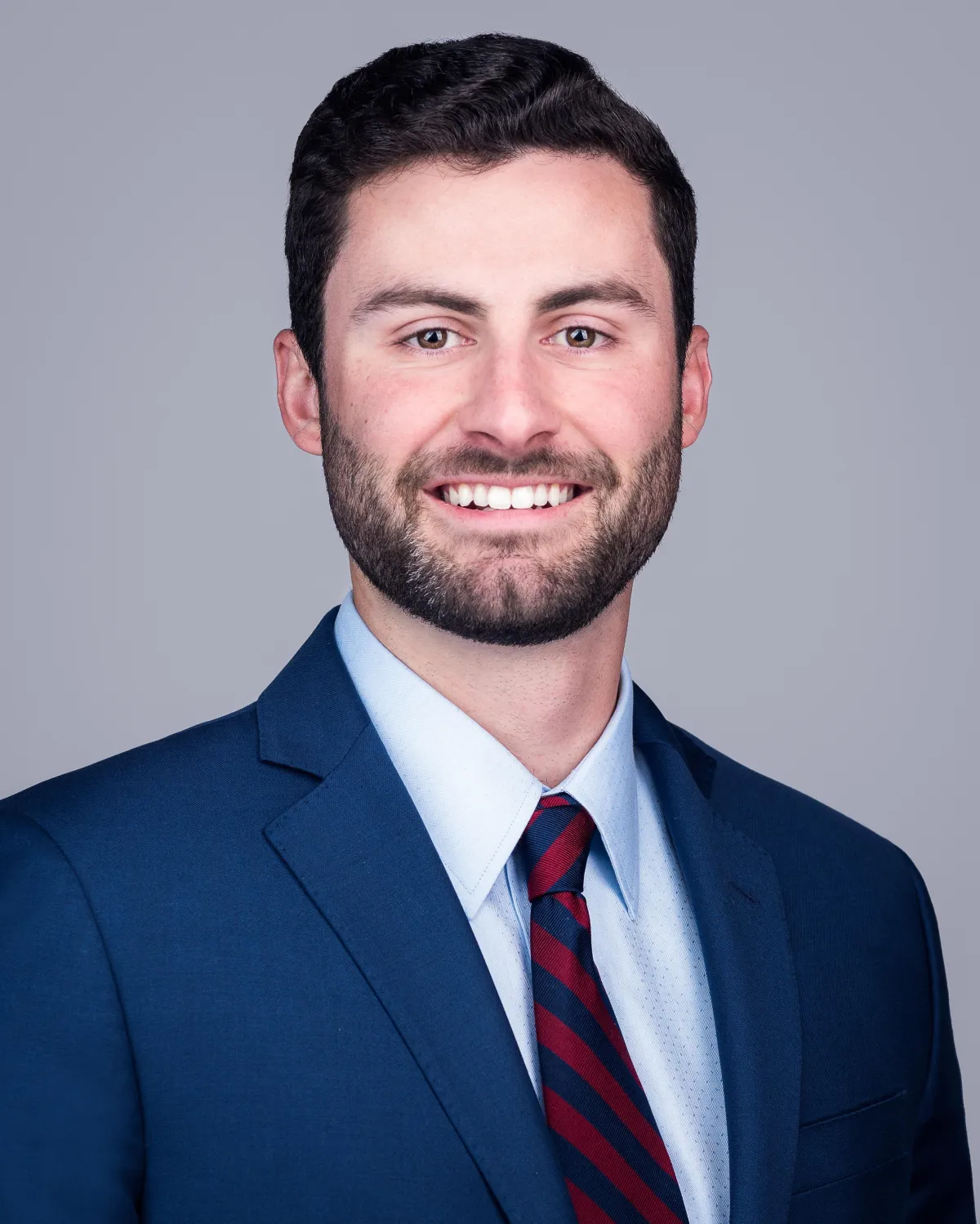 Man's headshot against dark gray background