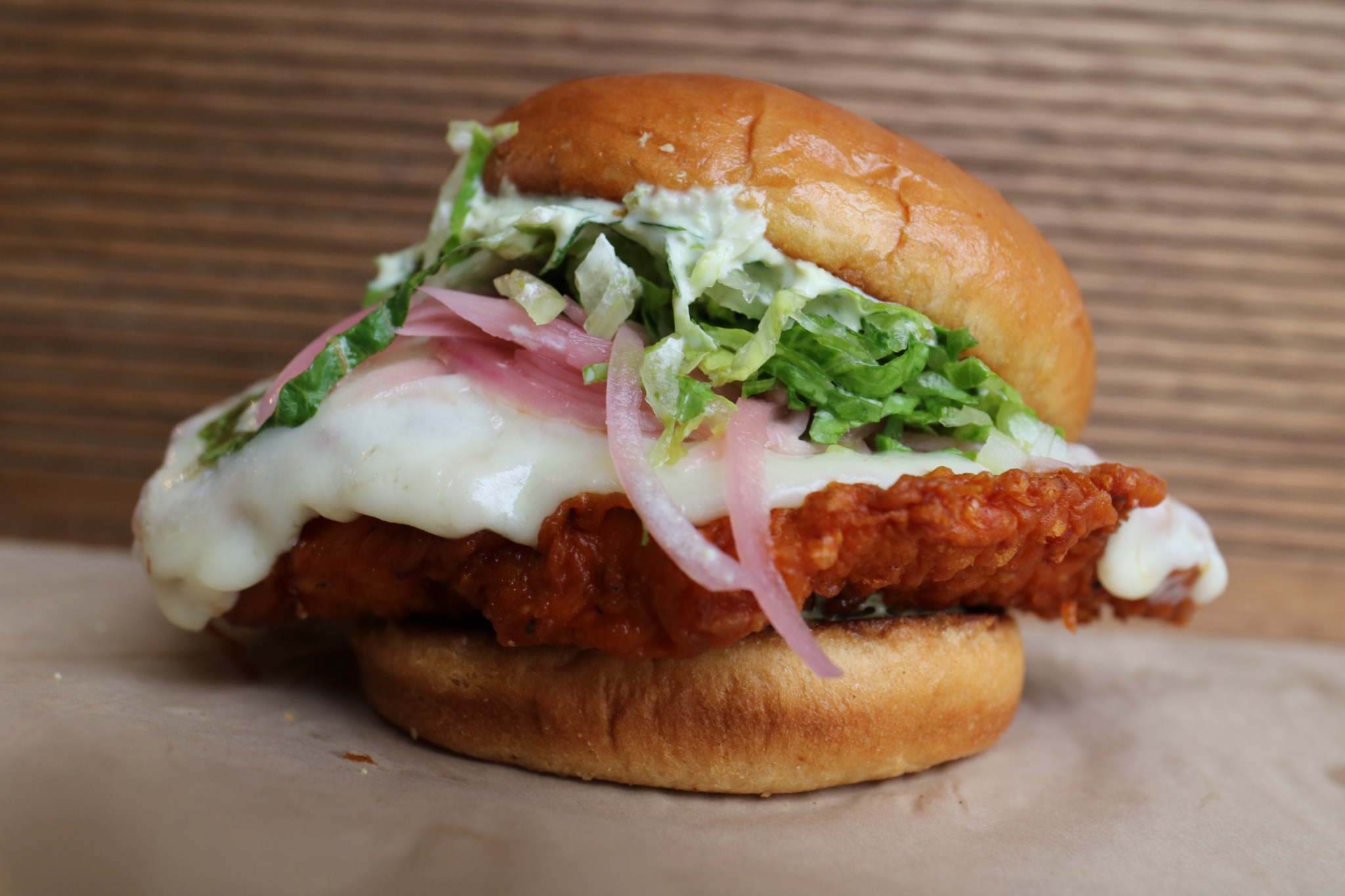 Volcano Stack sandwich with crispy chicken, gochujang slaw, and smoky chile crema