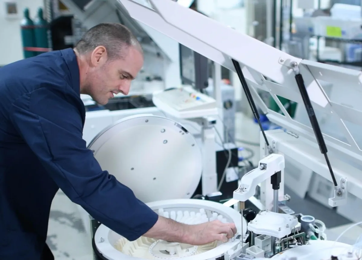 Man inspecting a mass spectrometer