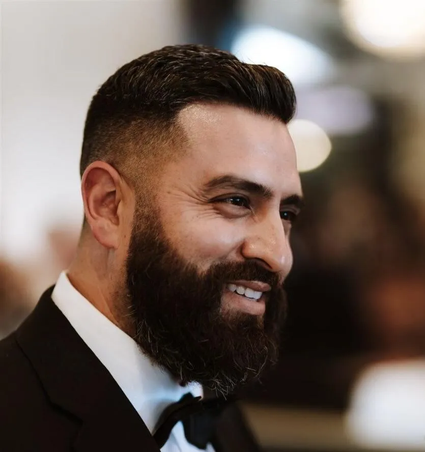 fields by duran: Alejandro Duran smiling with a beard wearing a tuxedo and bow tie at a formal event.