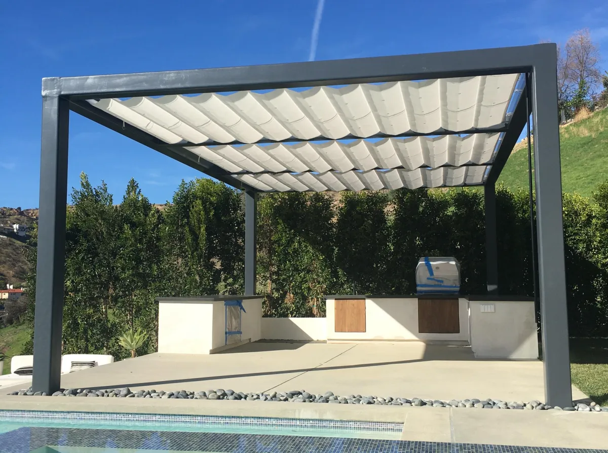 fields by duran: Modern outdoor patio with wooden pergola, comfortable lounge seating, neutral cushions, and garden greenery in the background.