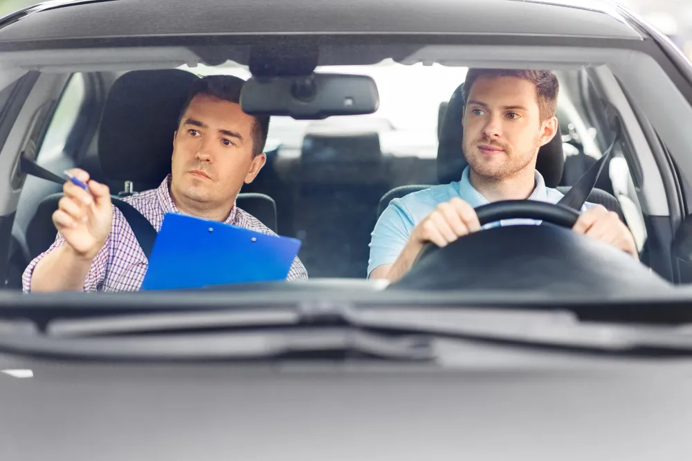 Teen driver practicing in a car with driving instructor