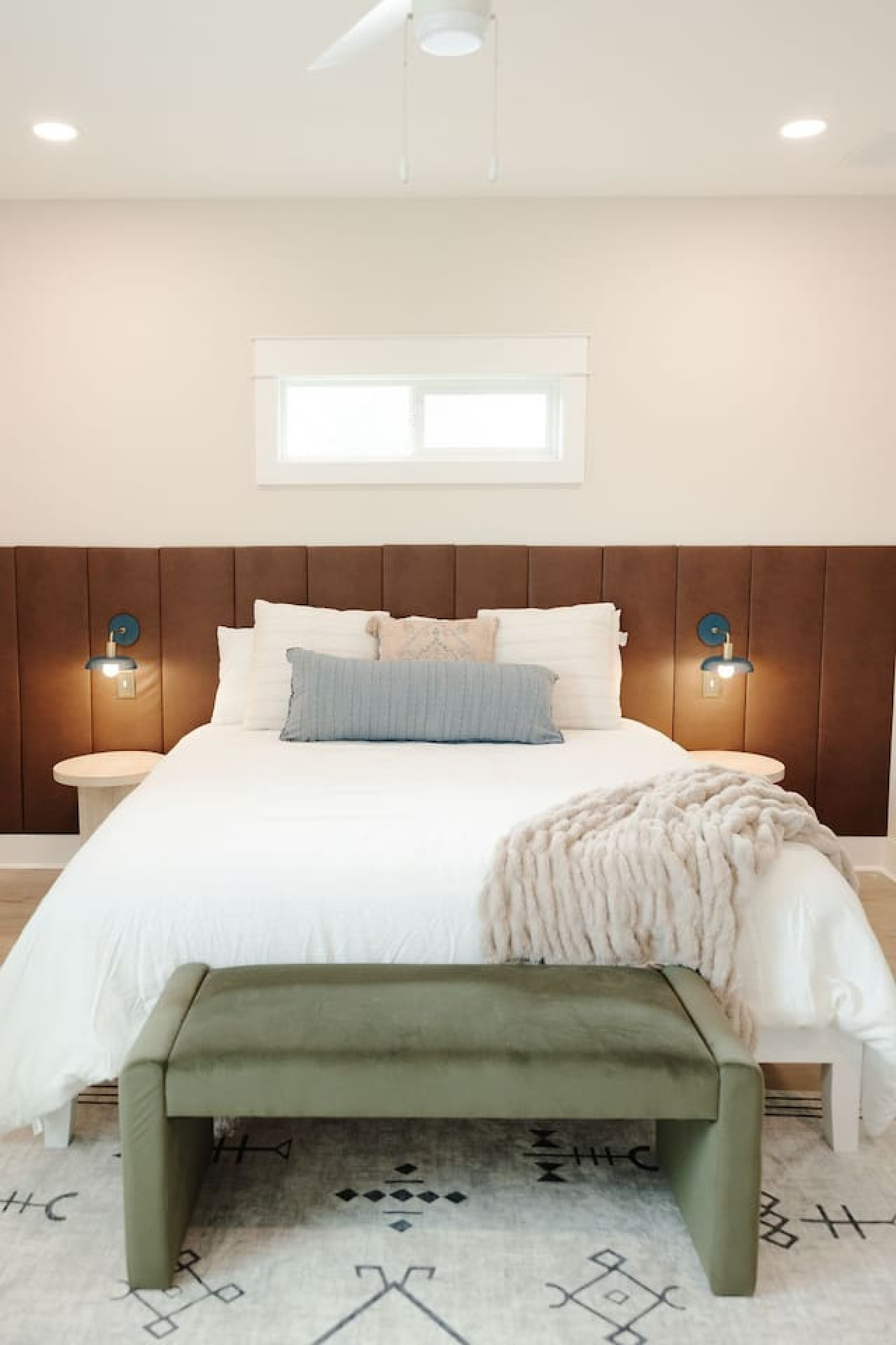 woman setting sheets on bed