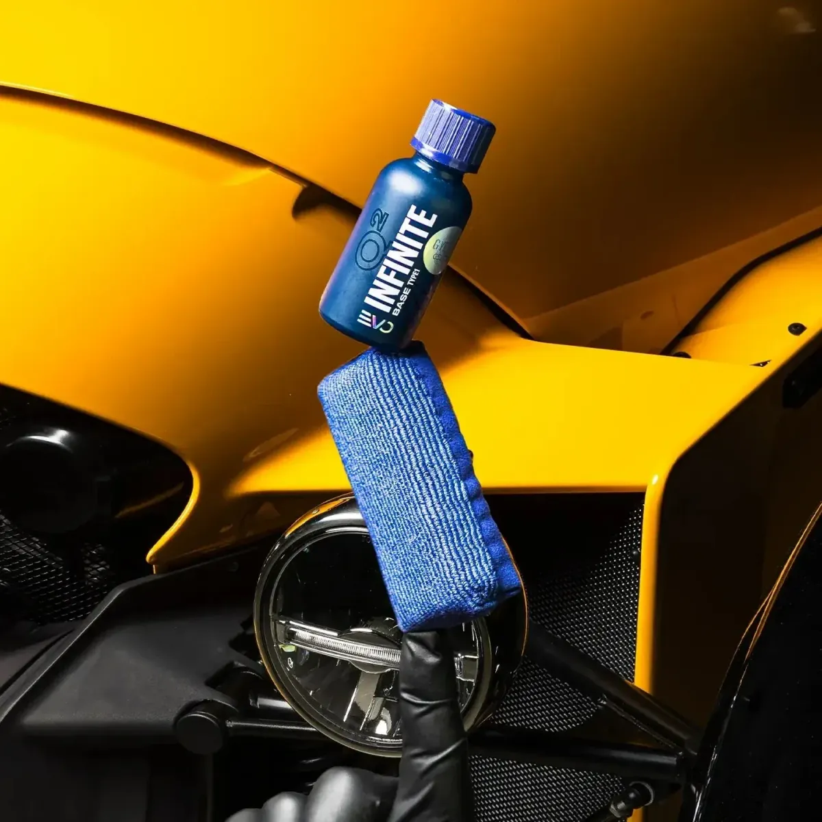 a man sanding a car with a polisher