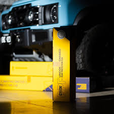 Small glass objects with purple lighting on reflective surface