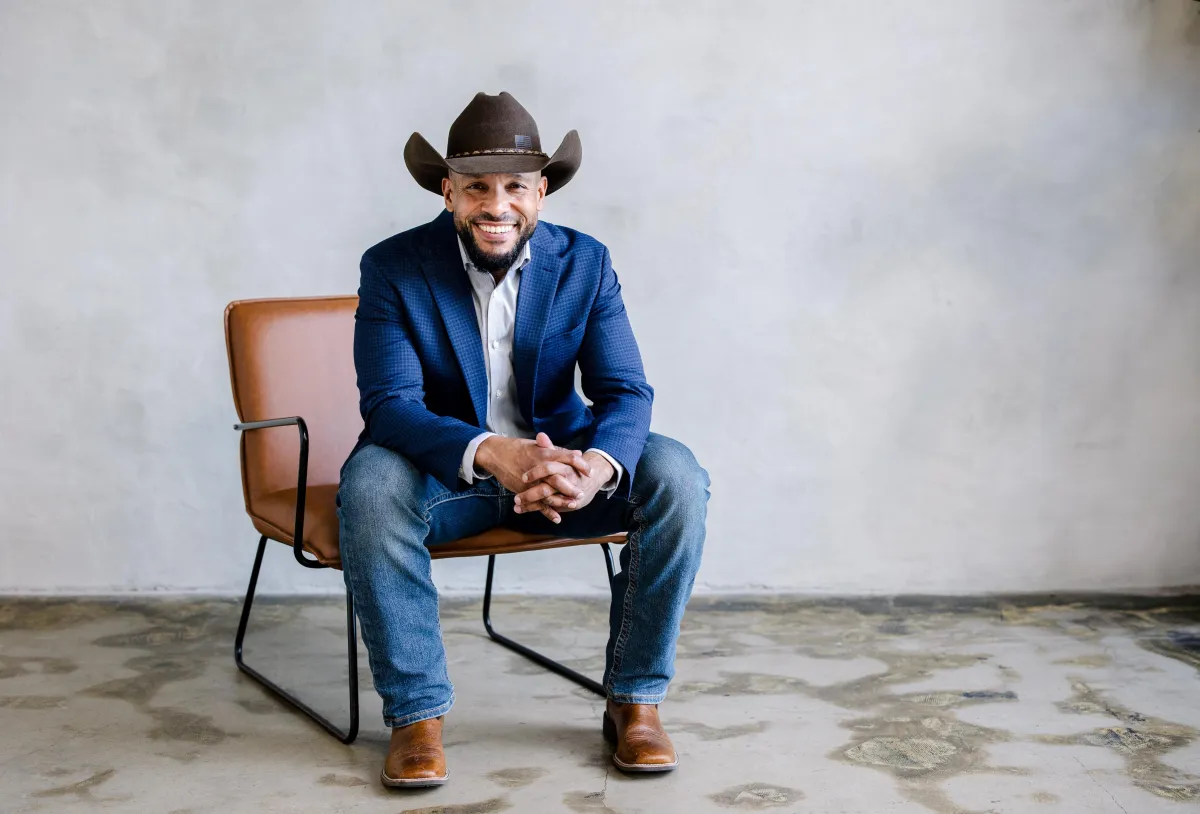 Jose Espejo, veteran and founder of Vaquero Landworks in Dublin, Georgia, standing in a blue blazer and cowboy hat, embodying integrity, precision, and reliable land clearing services.