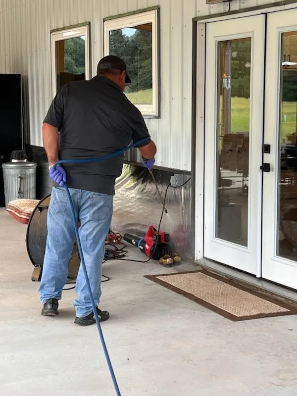 Pest control technician spraying outdoors