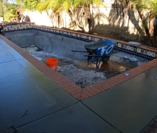 concrete deck wrapped around pool