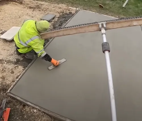 contractor finishing cement driveway