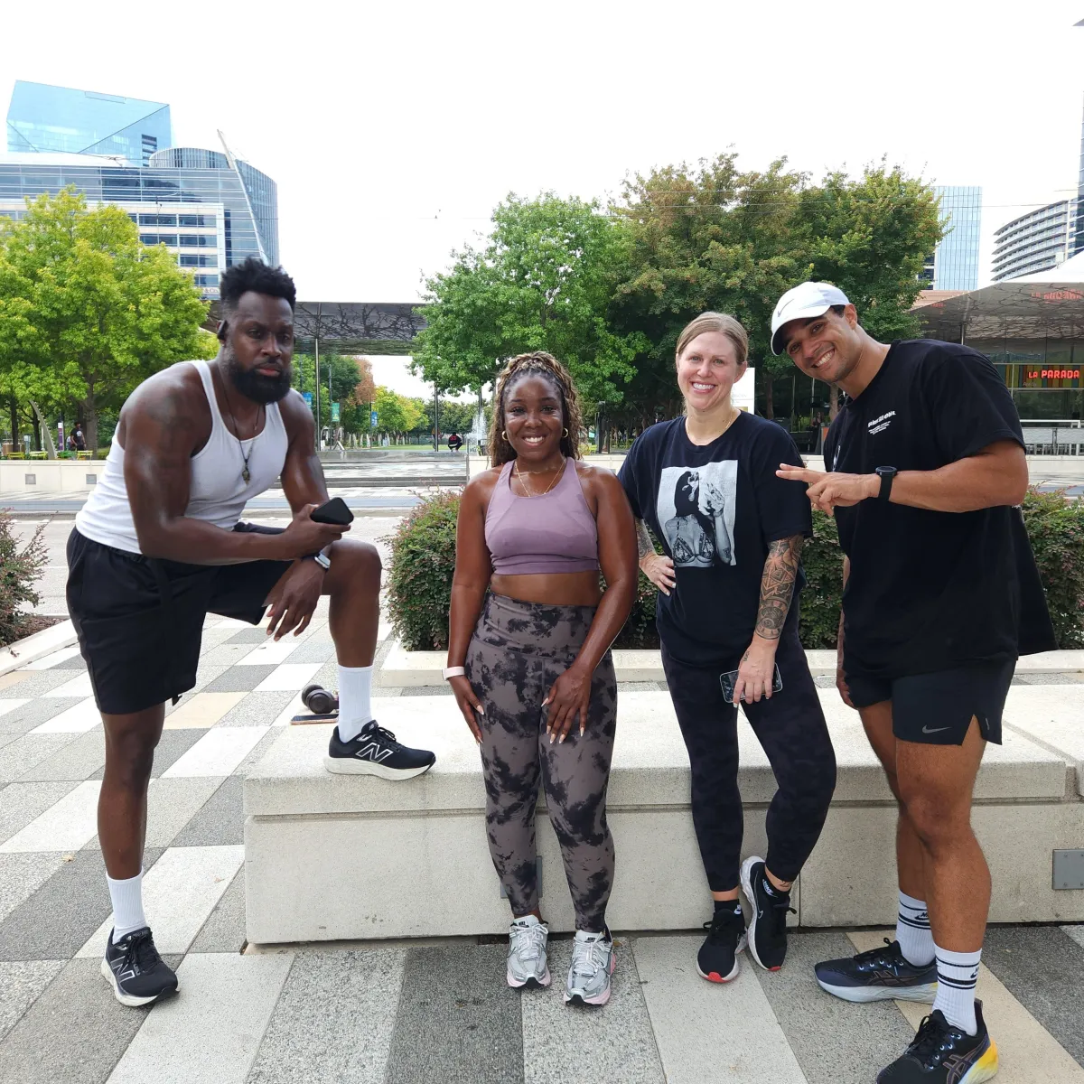 Group of fitness clients and coach from Wilson Wellness Solutions enjoying a successful outdoor workout session, showcasing teamwork and personalized training in Dallas.