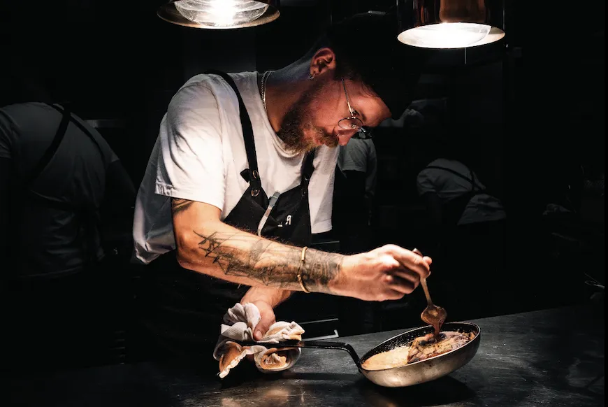 six white and brown eggs on white towel
