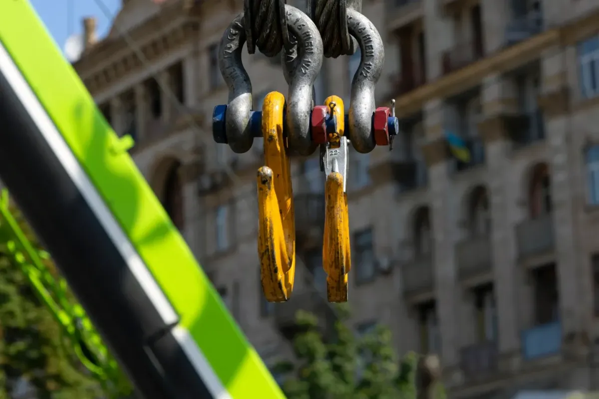 Close-up of crane hooks and lifting gear used for dogging and rigging operations on a construction site