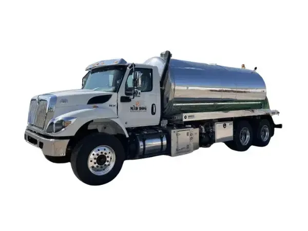 Midland, TX-based Mad Dog Services chrome tanker truck with a white cab, angled front shot