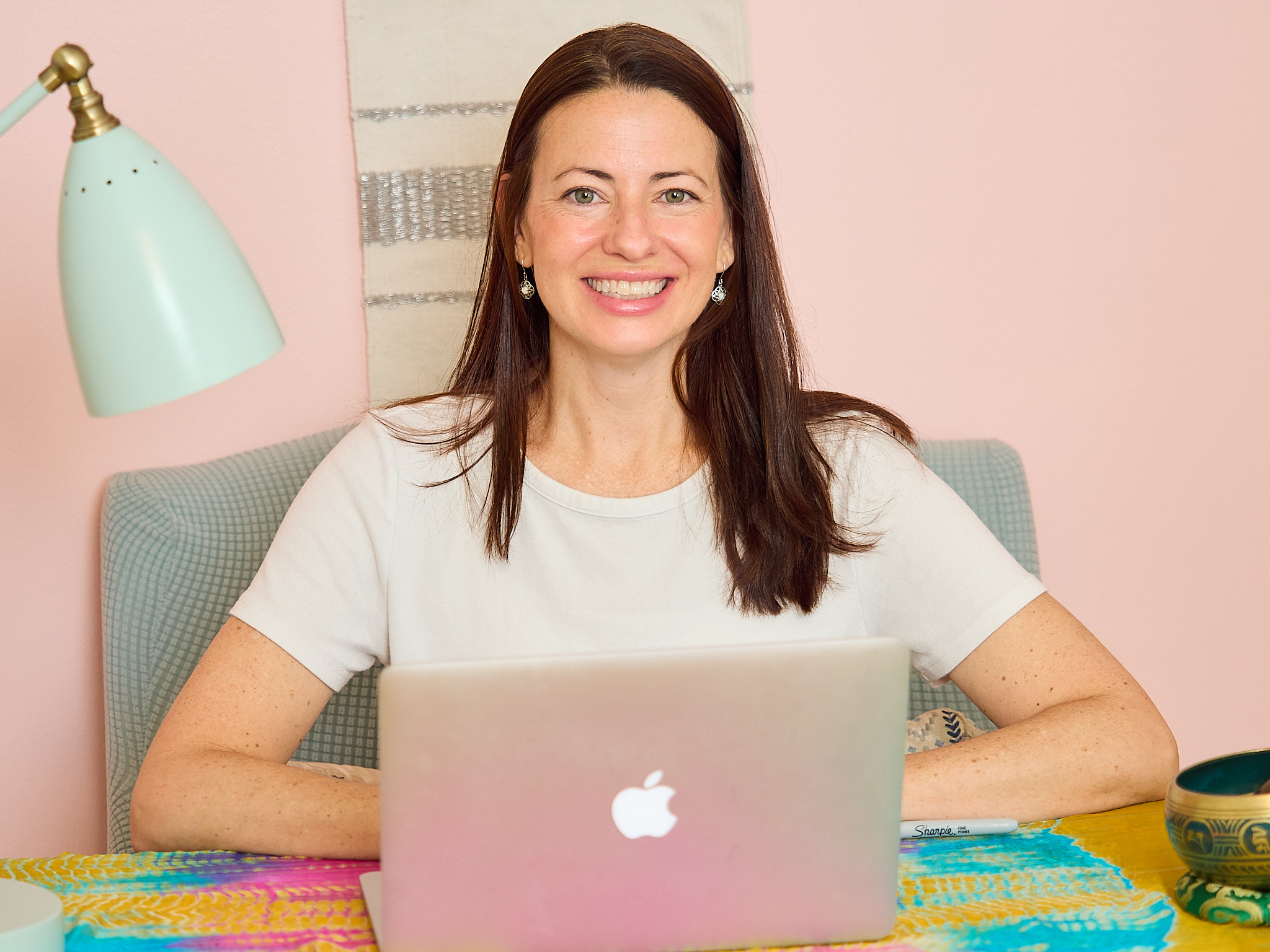 woman in black shirt and gray pants sitting on brown wooden bench