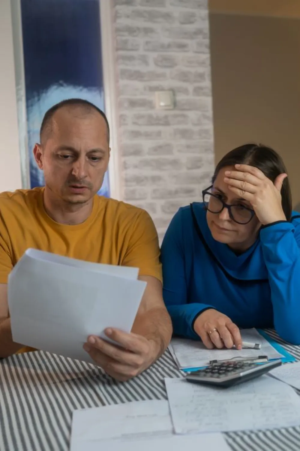 solar law firm prevost law firm - image of man and woman sitting at a table with papers looking stressed
